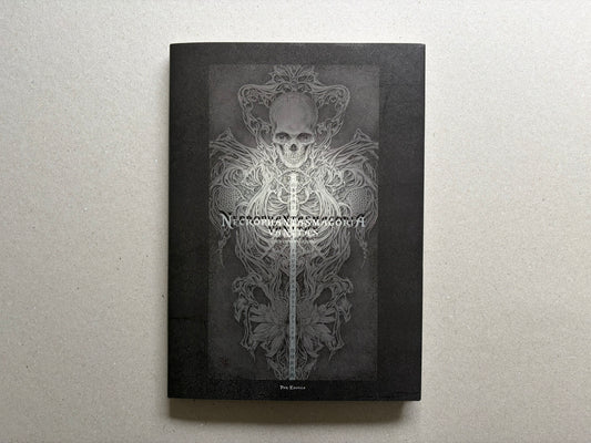 Necrophantasmagoria Vanitas by Takato Yamamoto, front cover with skull and ornamental figure on a black background.