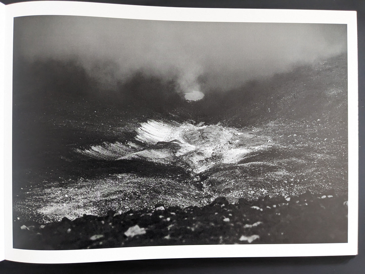 Crater-like form reflected in fog or water