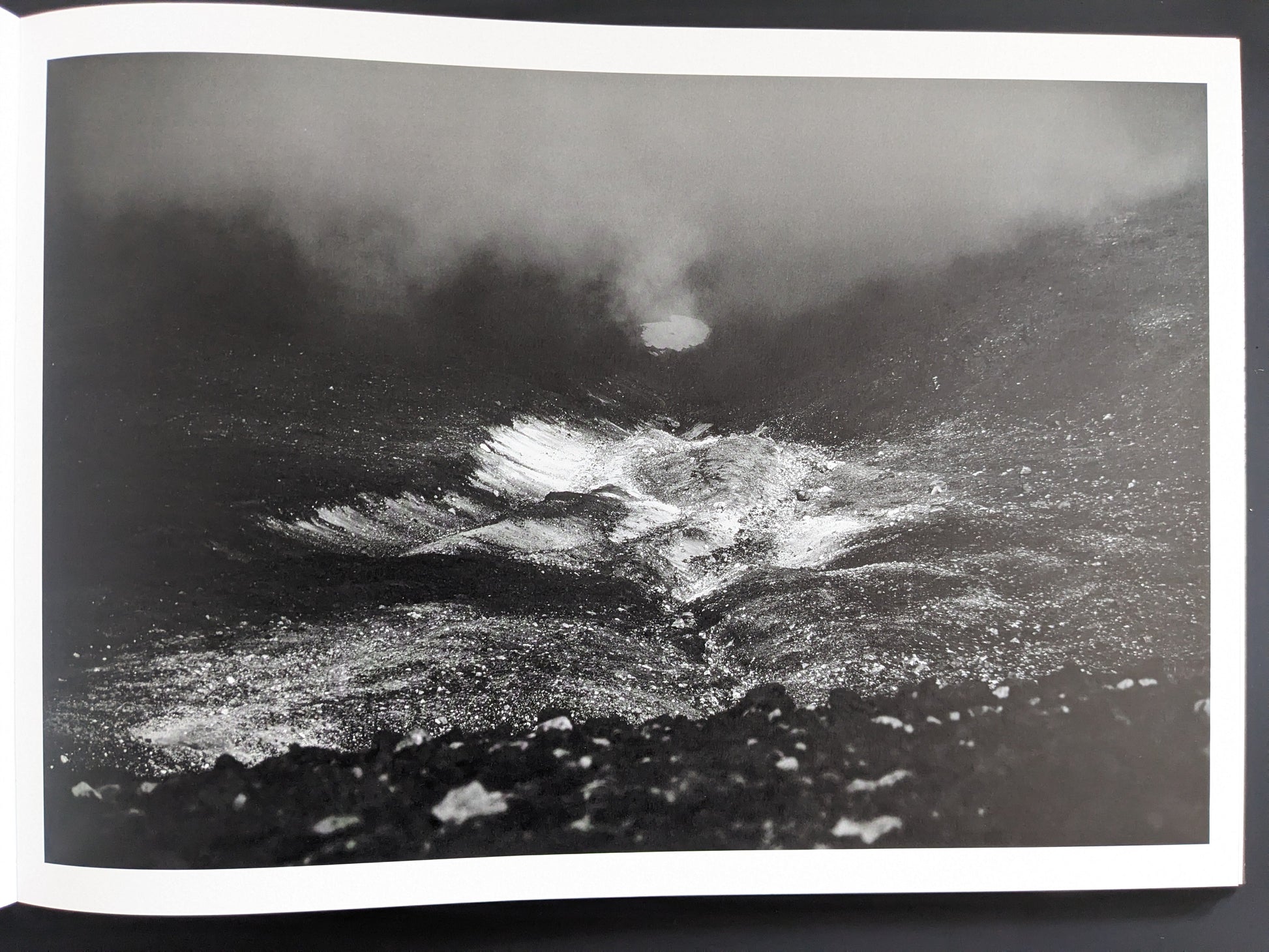 Crater-like form reflected in fog or water
