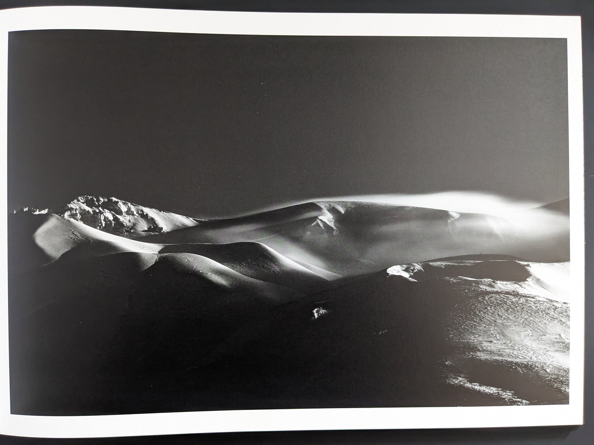 Snow forms shaped like dunes in black and white