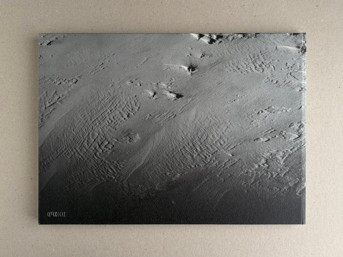 New Land: Pre-Hokkaido Landscapes by Toshiki Nakanishi, front cover with a monochrome aerial landscape image and small title mark at lower left.