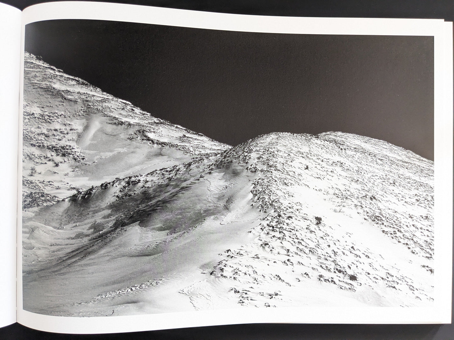 Snow-covered volcanic slope seen from above