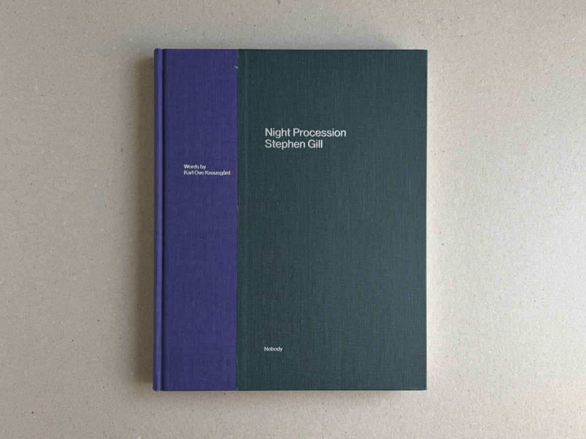 Front cover of Night Procession by Stephen Gill, a clothbound hardback with a purple spine and dark green cover.