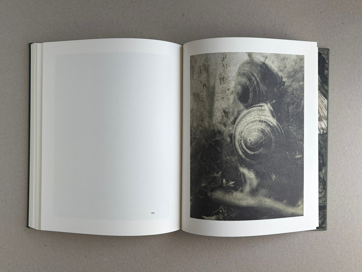 Night Procession by Stephen Gill, open photobook spread showing a full-page image on the right and a blank page on the left, with page 126 visible.