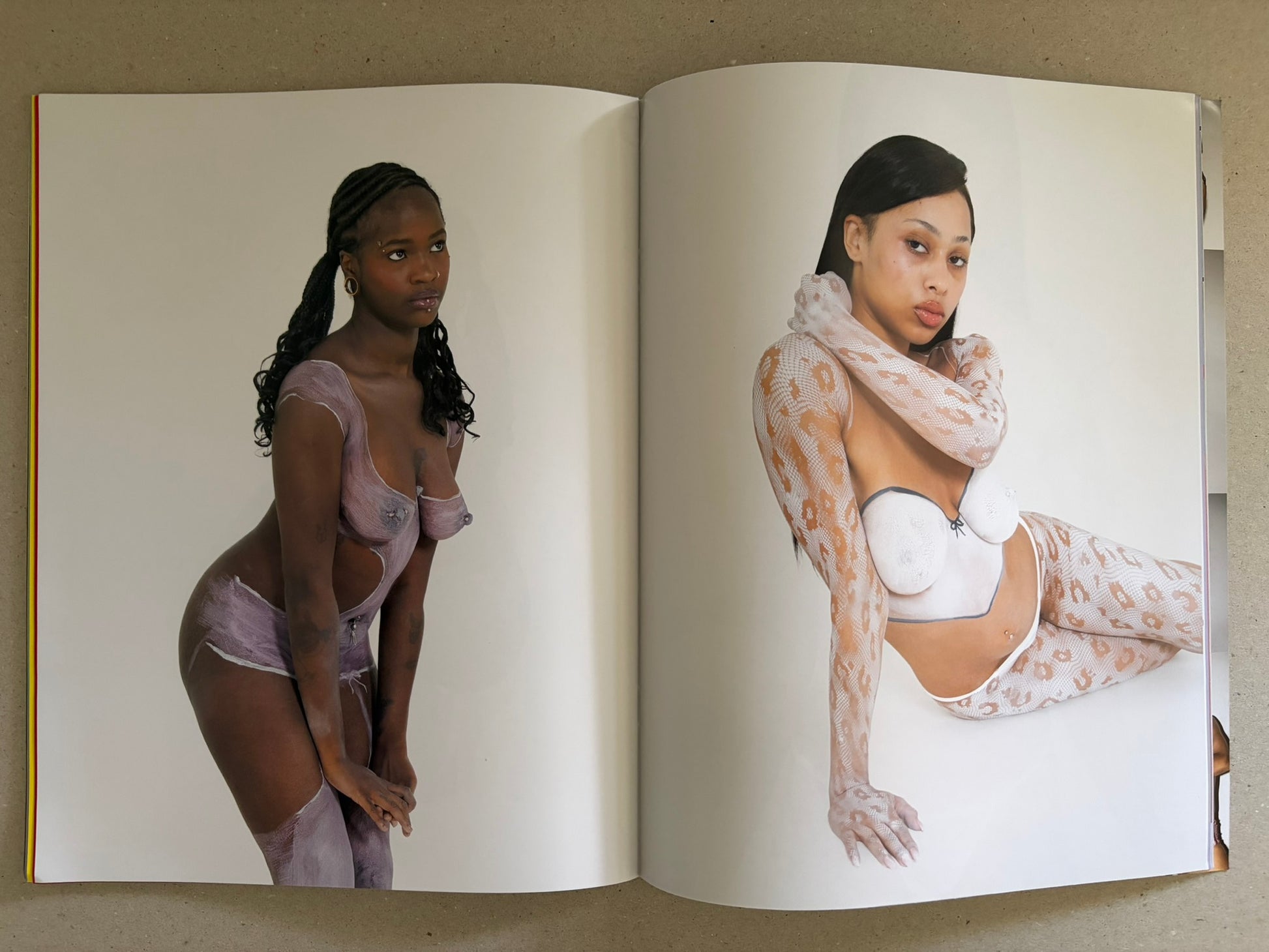 No Erotica No. 5 open to a white spread with two studio portraits of models in lingerie