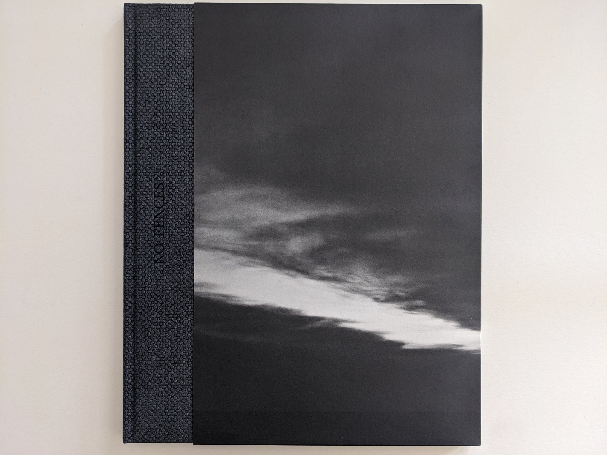 Front cover of 'No Fences' featuring a black-and-white cloud formation over a dark landscape