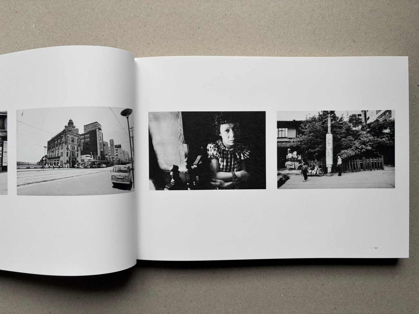 Nobuyoshi Araki, Sentimental Journey 1971–2017, open spread with small black-and-white city and portrait photographs