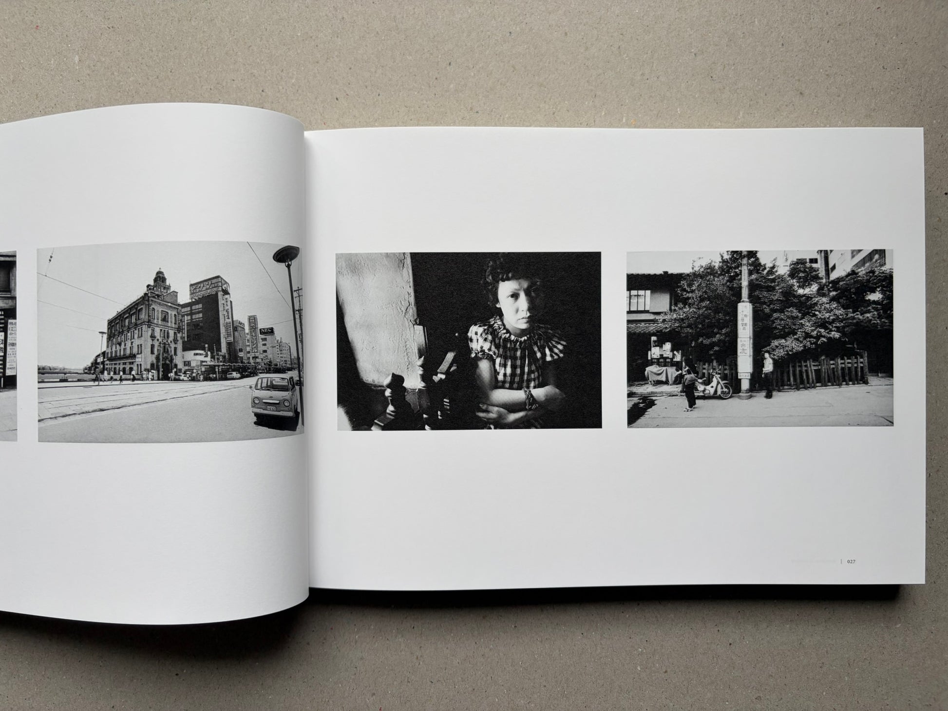 Nobuyoshi Araki, Sentimental Journey 1971–2017, open spread with small black-and-white city and portrait photographs