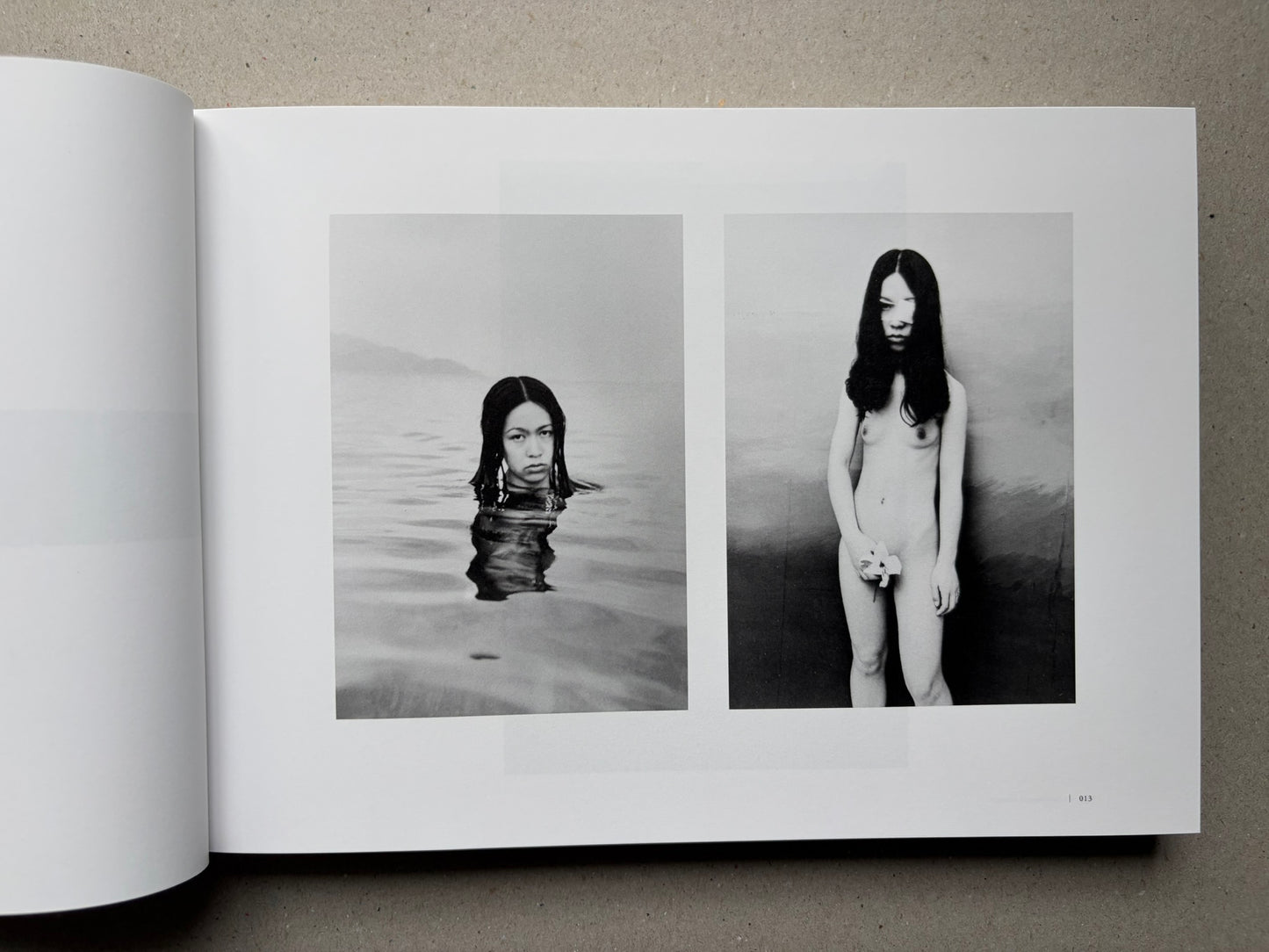 Nobuyoshi Araki, Sentimental Journey 1971–2017, open spread with two black-and-white photographs of a woman in water and standing nude
