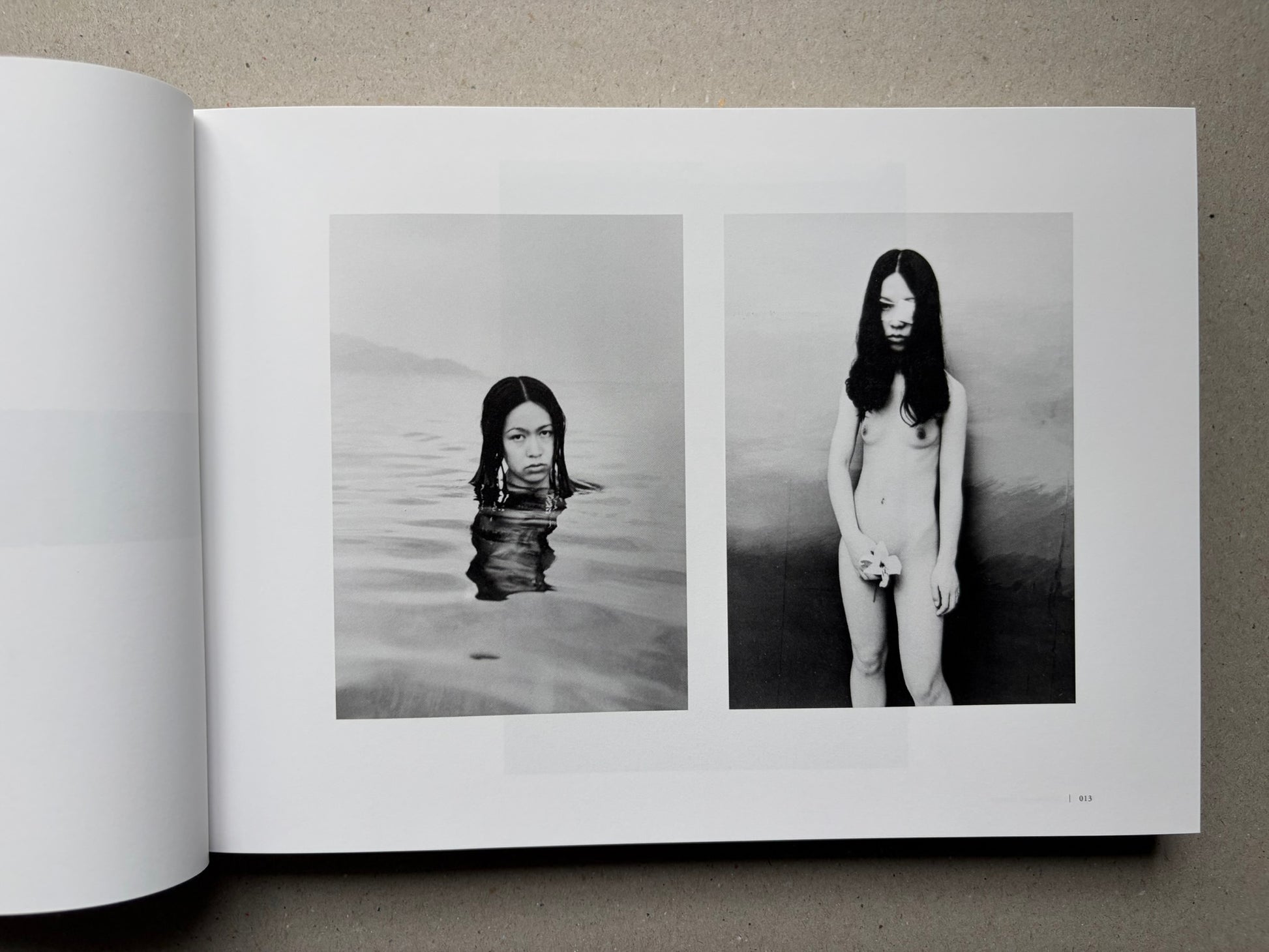 Nobuyoshi Araki, Sentimental Journey 1971–2017, open spread with two black-and-white photographs of a woman in water and standing nude
