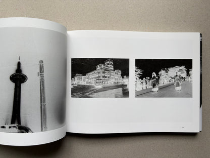 Nobuyoshi Araki, Sentimental Journey 1971–2017, open spread with black-and-white street and skyline photographs