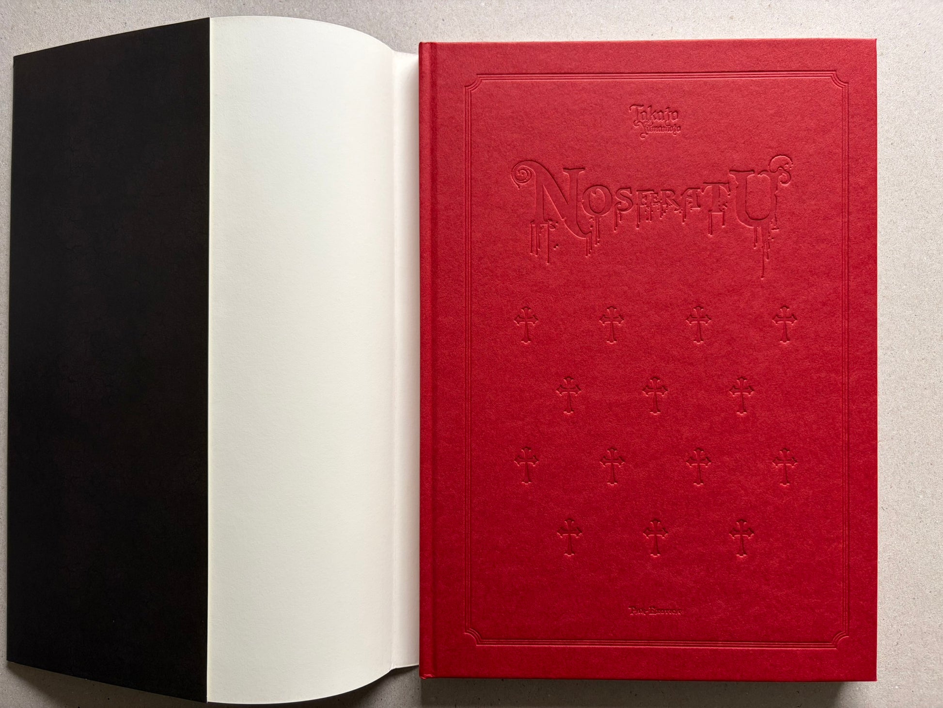 NOSFERATU by Takato Yamamoto, open to the red embossed hardcover and black endpaper.