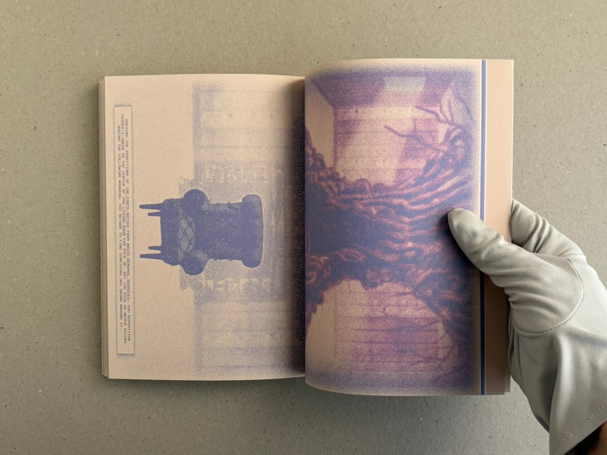 Open spread of Nostalgia Nest – The Salamander King, showing a printed page on the left and a purple-toned illustration on the right, with a gloved hand holding the book open.