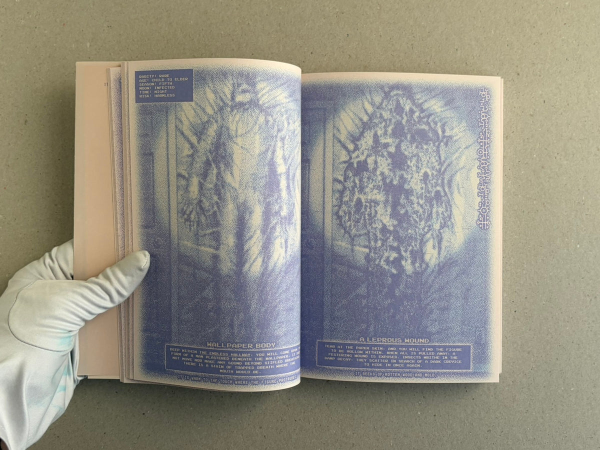 Open spread of Nostalgia Nest – The Salamander King showing two blue-toned illustrated pages with small text panels, held open by a gloved hand.