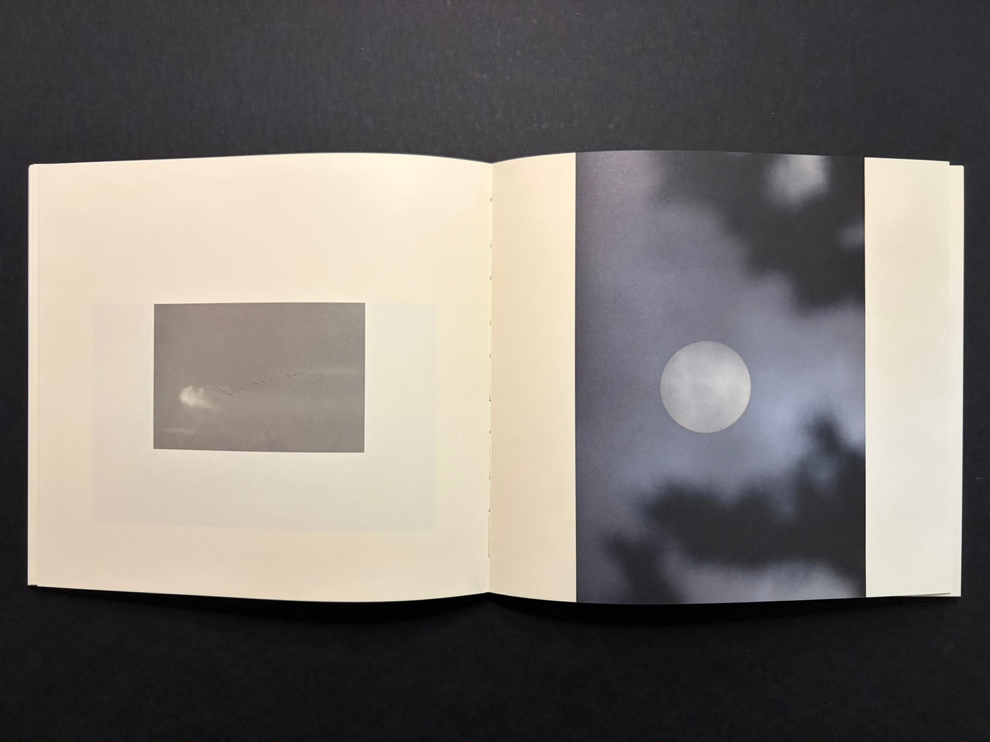 Open Nusa spread with a pale circular image on the right page