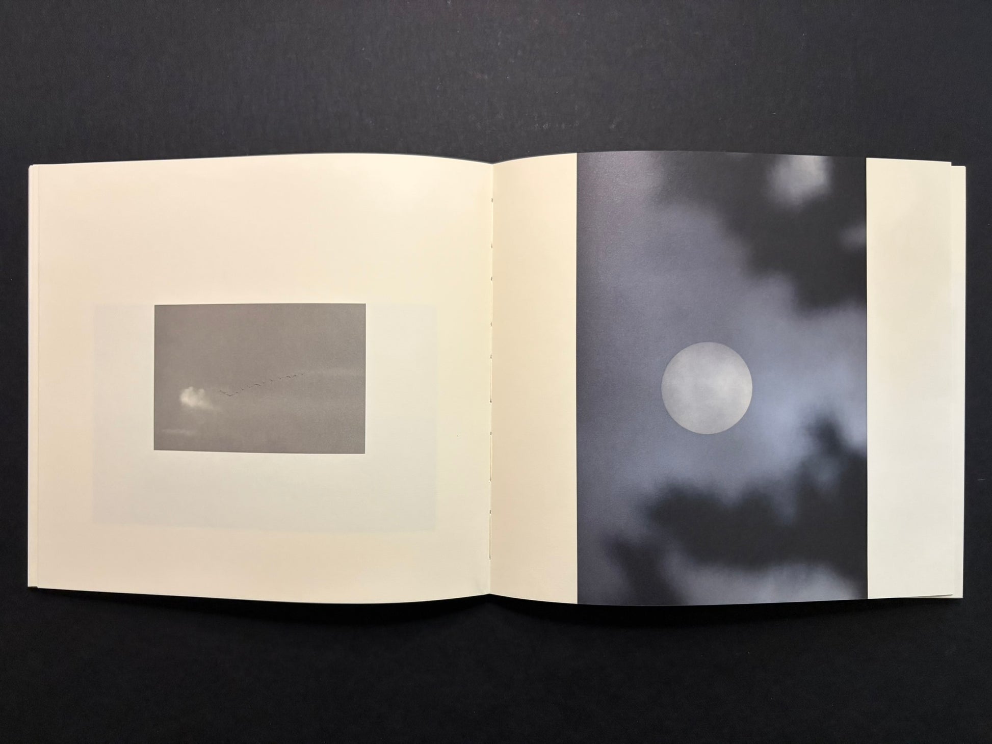 Open Nusa spread with a pale circular image on the right page