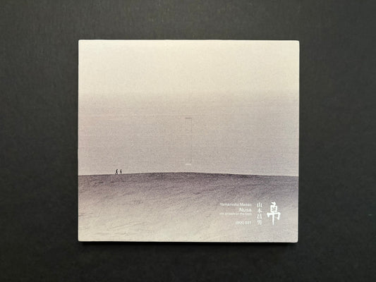 Nusa by Masao Yamamoto, front cover on a dark background