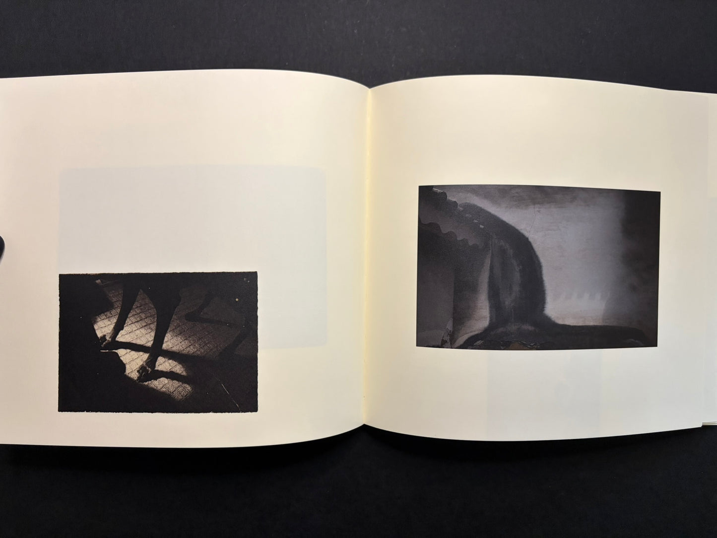 Open Nusa spread with two small black-and-white photographs on facing pages