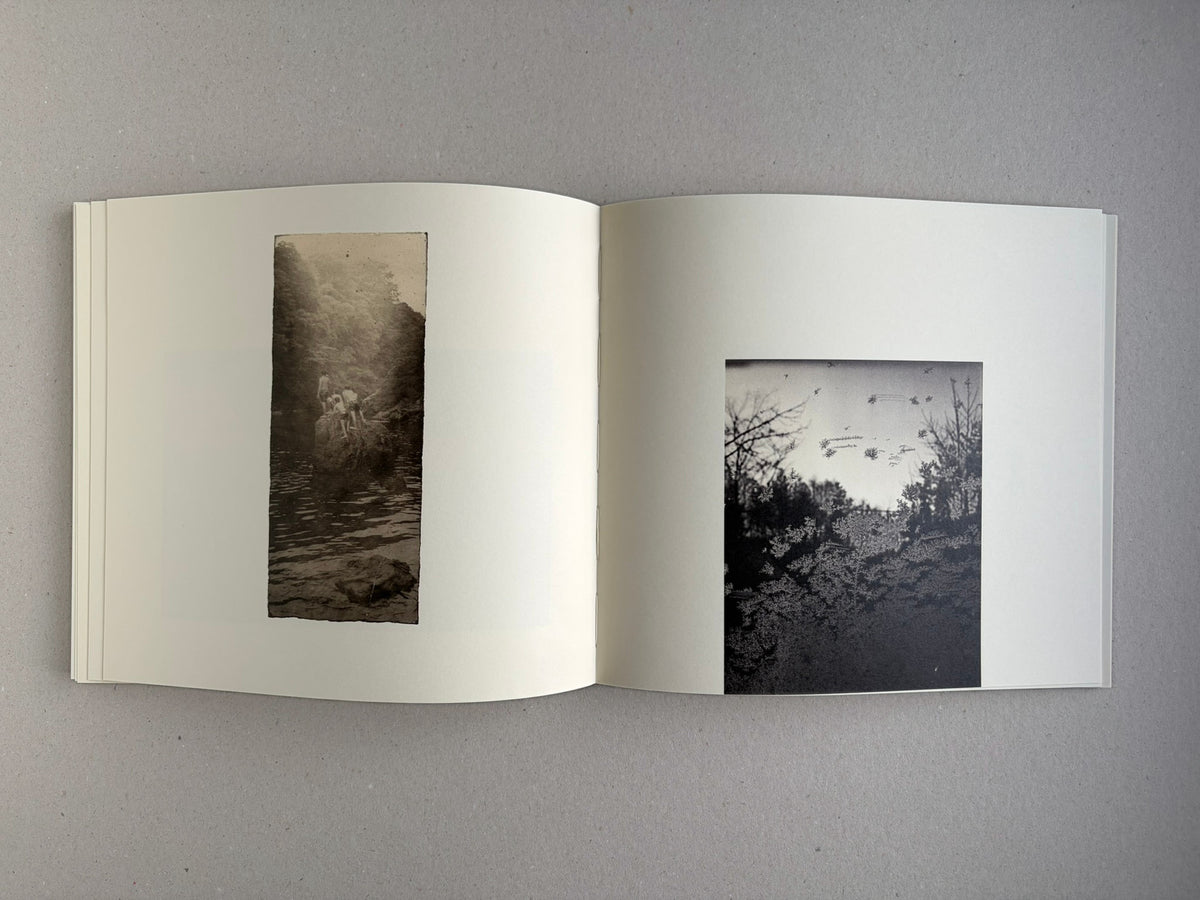 Nusa by Masao Yamamoto, open spread with a landscape image and a clouded seascape