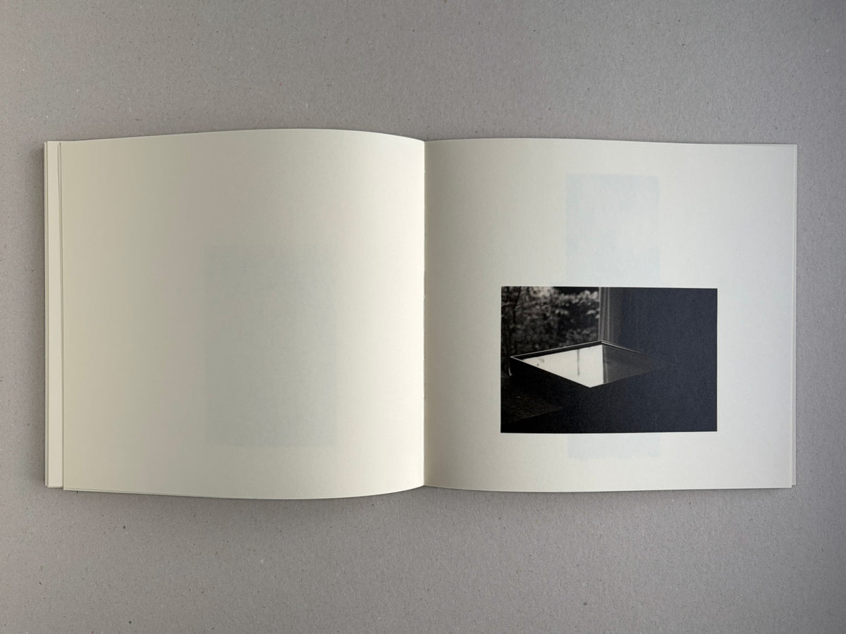 Nusa by Masao Yamamoto, open spread with a small dark image on the right page
