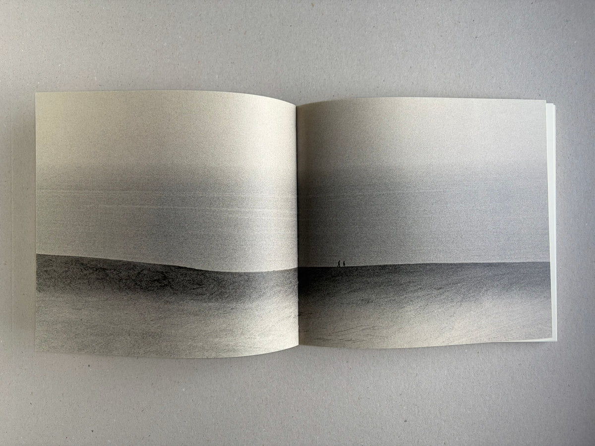 Nusa by Masao Yamamoto, open spread with a wide landscape photograph