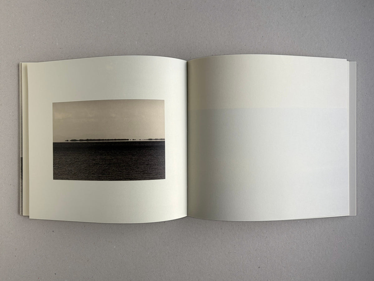 Nusa by Masao Yamamoto, open spread with a small landscape image on the left page