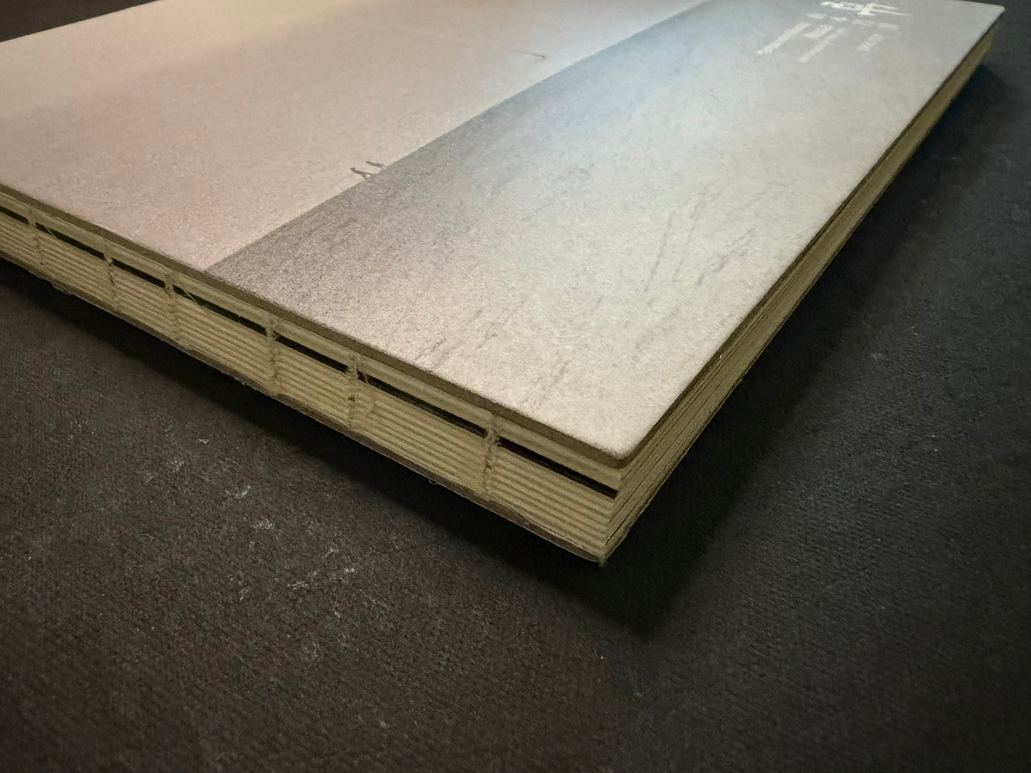 Nusa by Masao Yamamoto, hardcover shown from the spine and cover edge