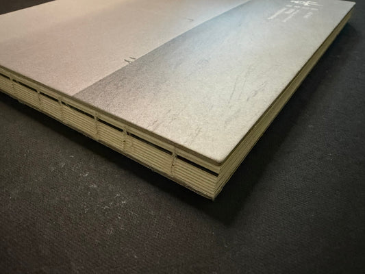 Nusa by Masao Yamamoto, hardcover shown from the spine and cover edge