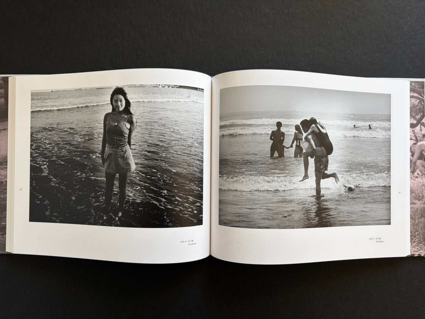 Interior spread with a young woman standing in the sea and people playing in the water at Enoshima.