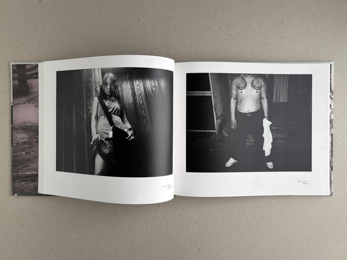 Open spread of Obi and Sand: Kyoto/Enoshima showing two black-and-white photographs, one of a woman standing by a wall and one of a shirtless man with tattooed shoulders.