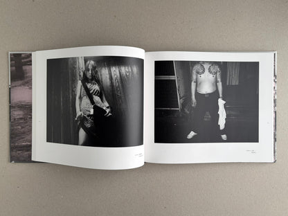 Open spread of Obi and Sand: Kyoto/Enoshima showing two black-and-white photographs, one of a woman standing by a wall and one of a shirtless man with tattooed shoulders.
