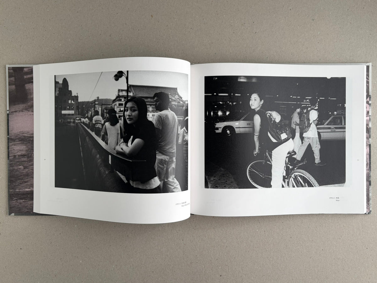 Open photobook spread from Obi and Sand: Kyoto/Enoshima by Yoshio Mizoguchi, showing two black-and-white street photographs on facing pages.