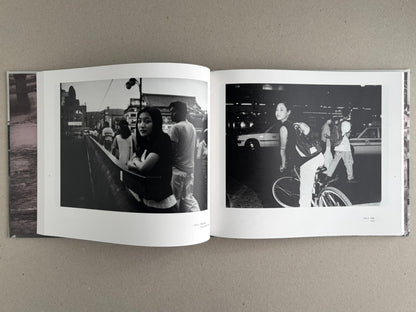 Open photobook spread from Obi and Sand: Kyoto/Enoshima by Yoshio Mizoguchi, showing two black-and-white street photographs on facing pages.