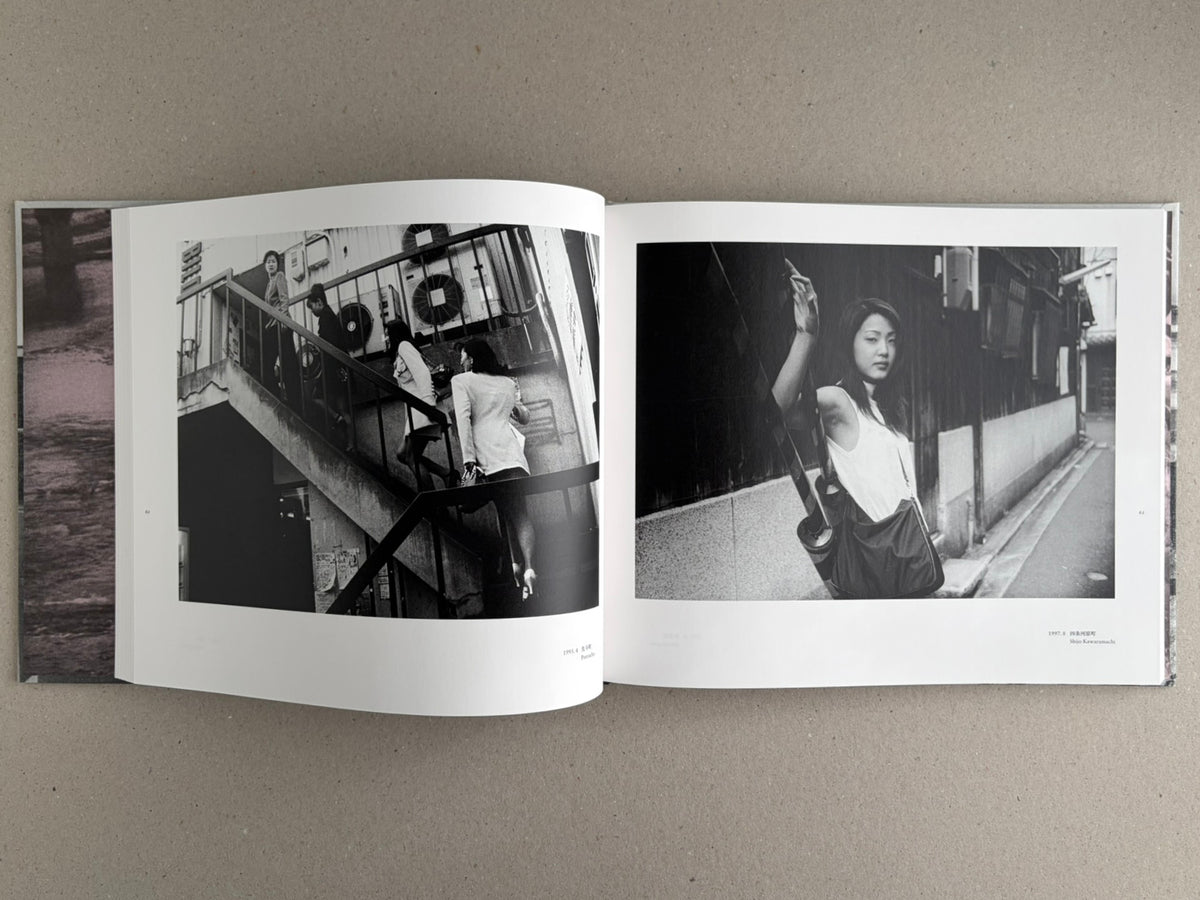 Open photobook spread from Obi and Sand: Kyoto/Enoshima by Yoshio Mizoguchi, showing two black-and-white street photographs across facing pages.