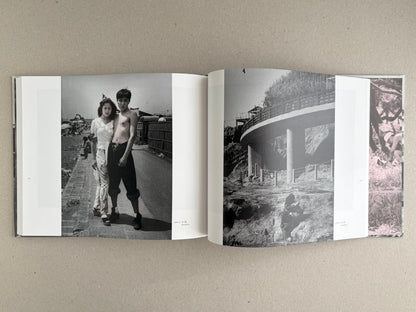 Open spread from Obi and Sand: Kyoto/Enoshima showing black-and-white photographs, including a couple standing on a seaside path and a curved structure on a rocky shore.
