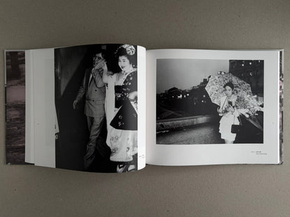Open photobook spread from Obi and Sand: Kyoto/Enoshima by Yoshio Mizoguchi, showing two black-and-white photographs on facing pages.