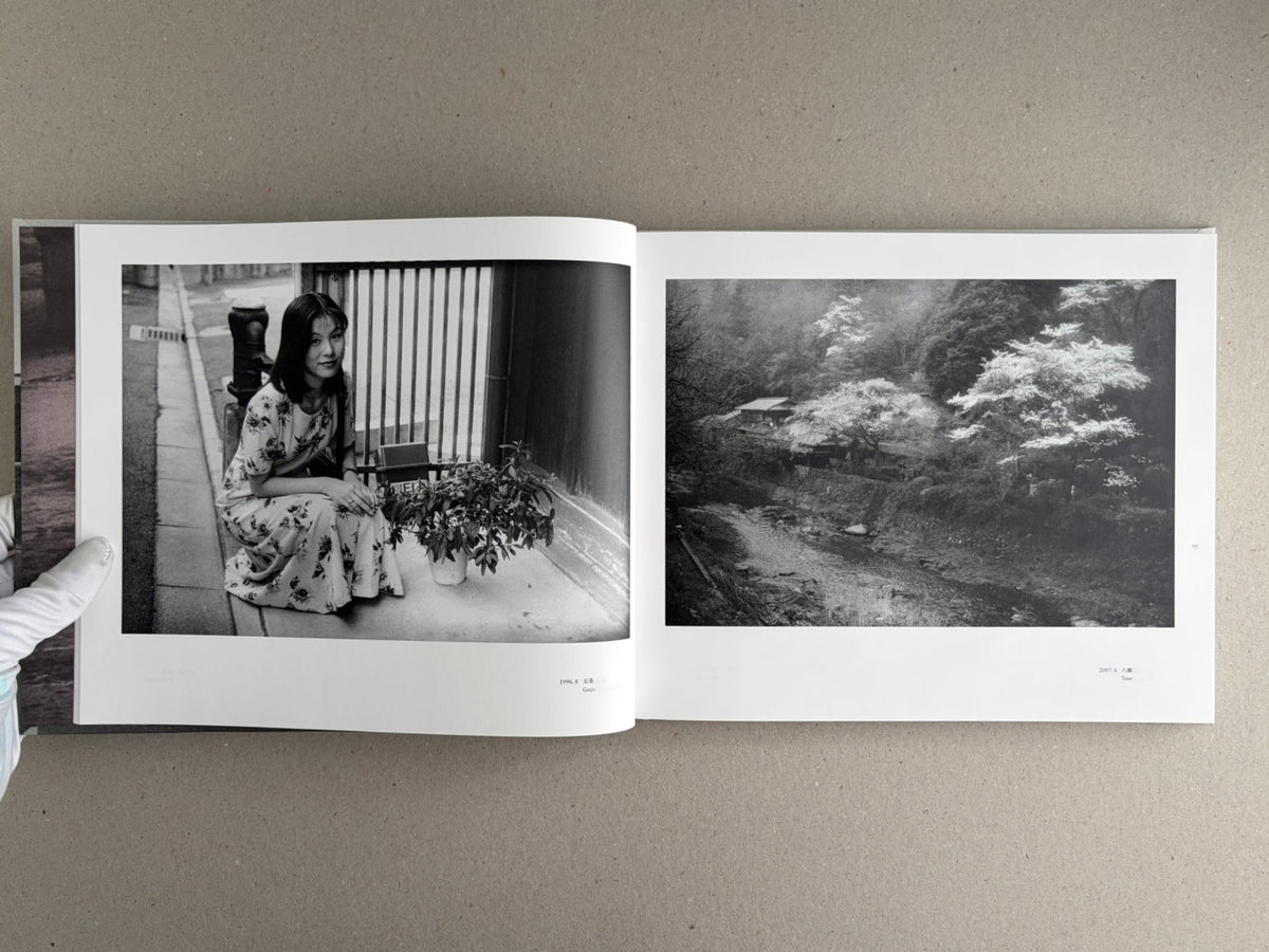 Open spread of Obi and Sand: Kyoto/Enoshima by Yoshio Mizoguchi, showing a black-and-white portrait on the left page and a landscape on the right page.