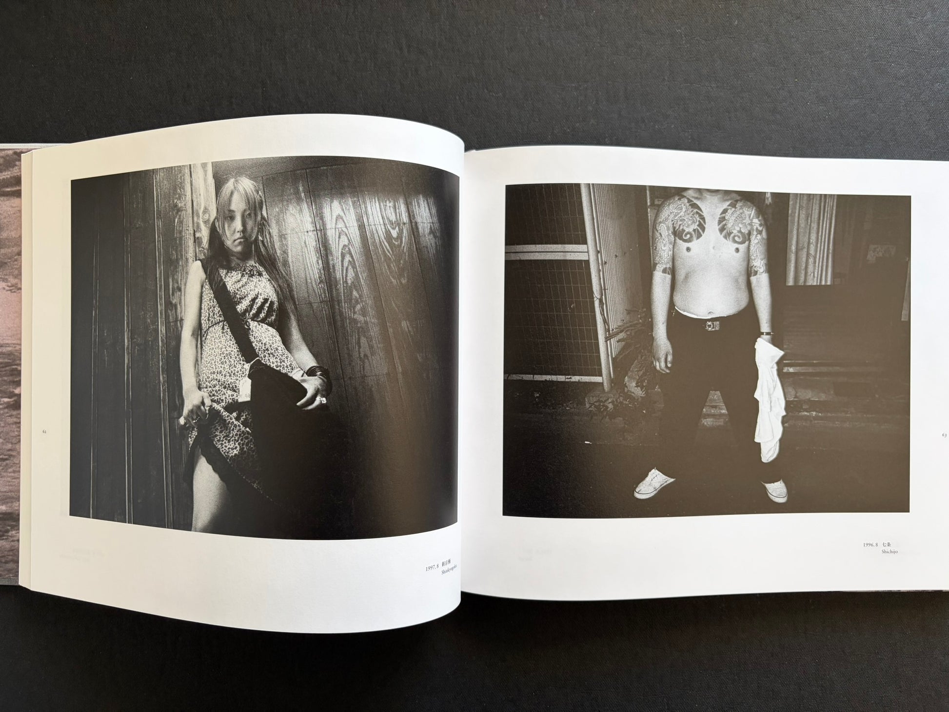 Interior spread with a portrait of a young woman and a tattooed man in black and white.