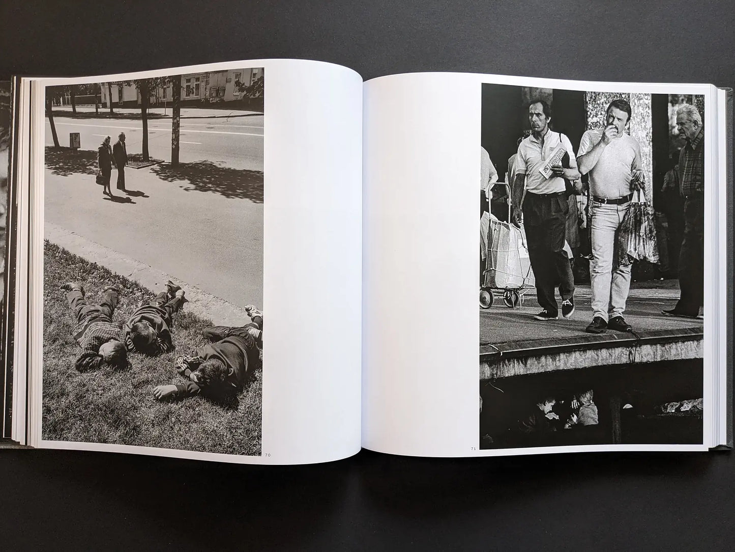 Spread from Oleksandr Glyadyelov photobook with children sleeping on grass on one side and passersby walking along a market platform on the other.