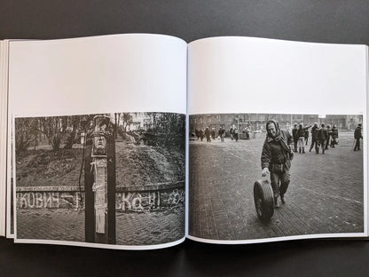 Oleksandr Glyadyelov images of a protest effigy tied to a post and a man rolling a tyre across a city square after demonstrations.