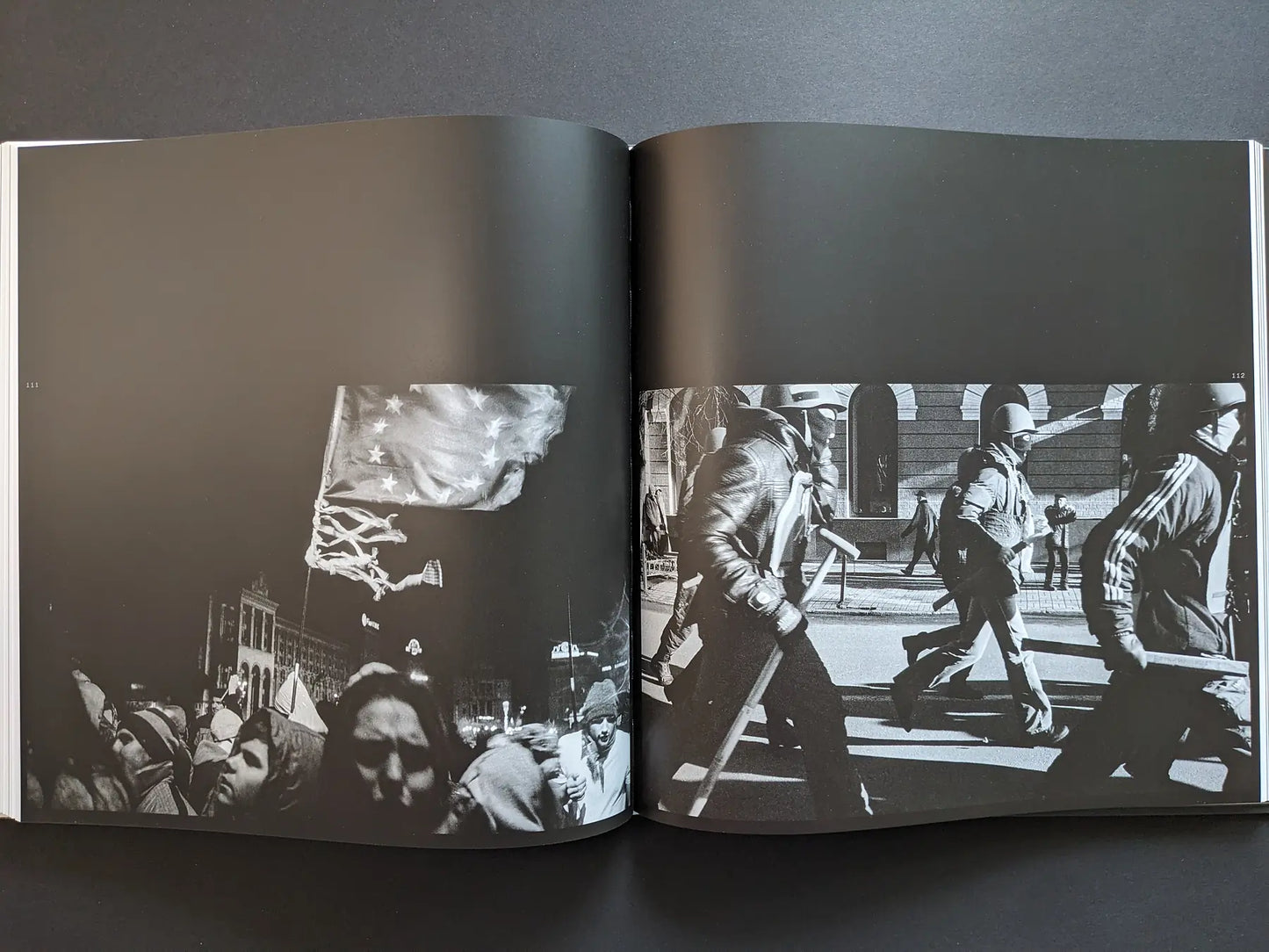 Protest spread from Oleksandr Glyadyelov book showing crowds with an EU flag at night and helmeted demonstrators marching in daylight.