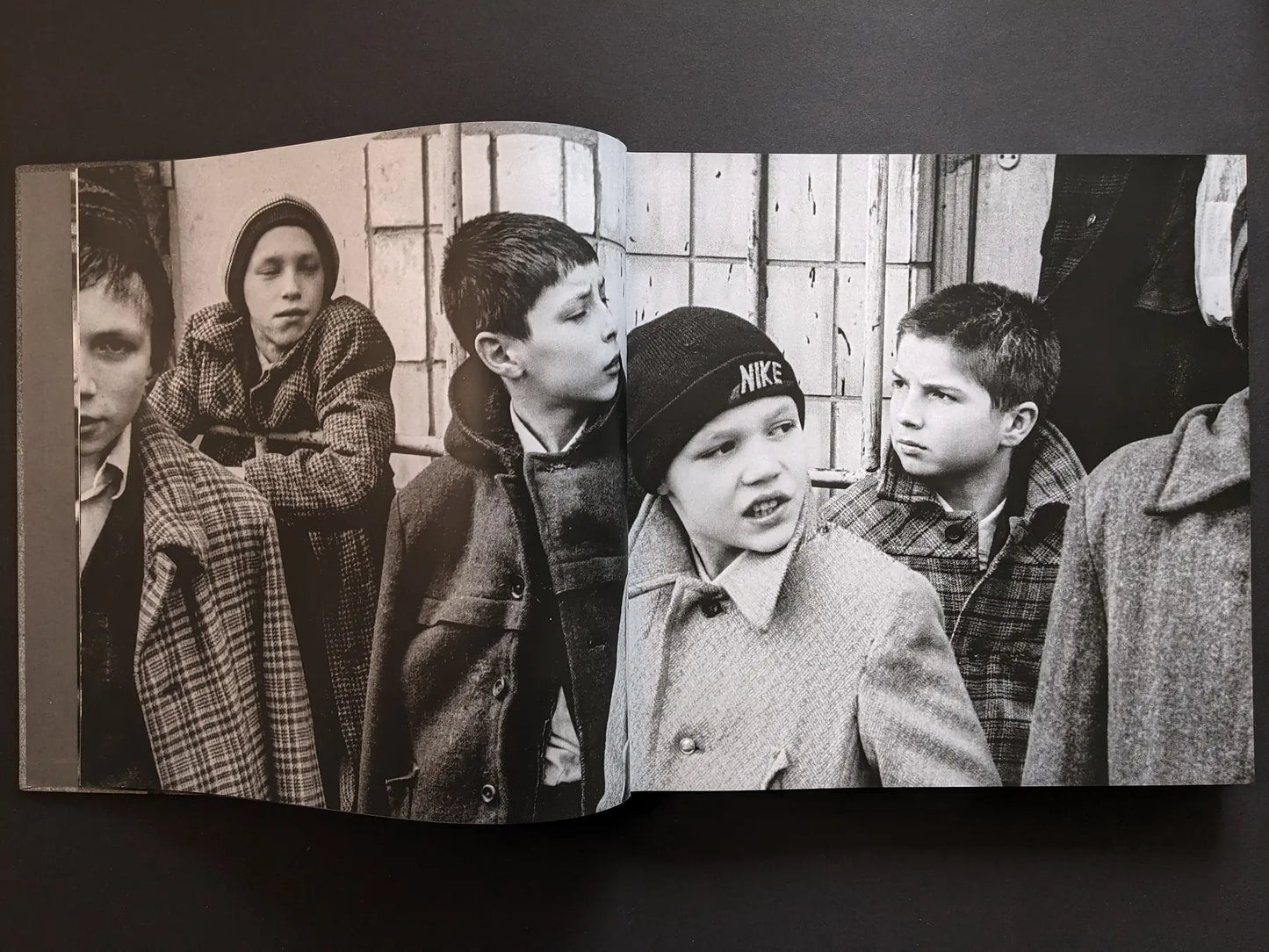 Inside spread from Oleksandr Glyadyelov with a group of boys standing together outside on a city street.