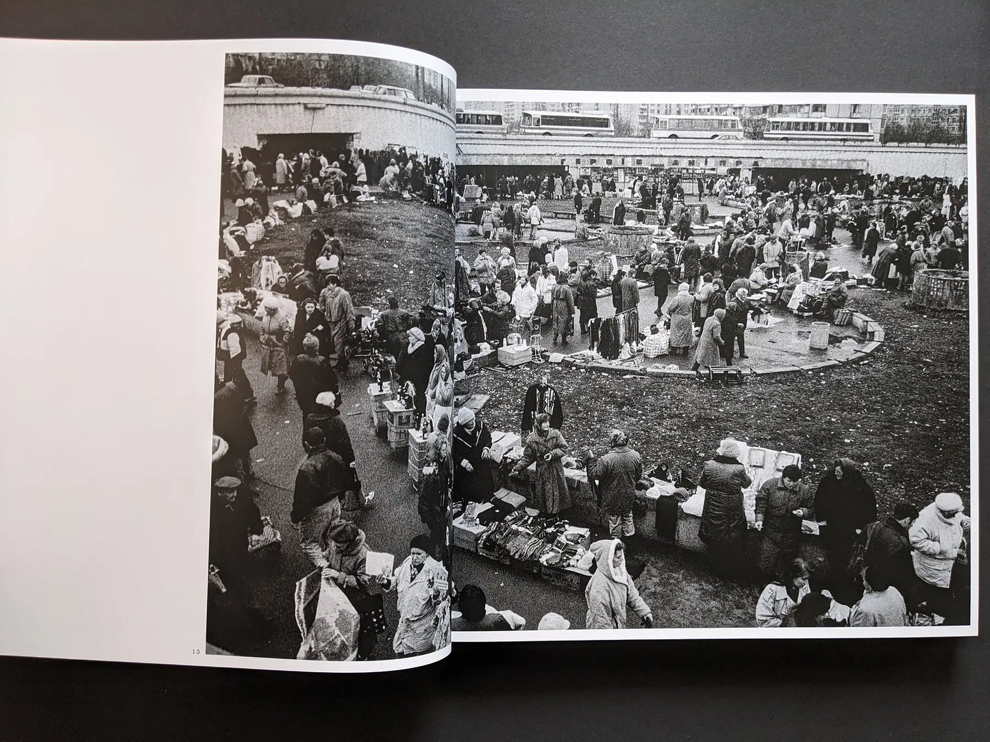 Inside spread from Oleksandr Glyadyelov depicting a crowded open-air market with stalls, vendors and shoppers seen from above.