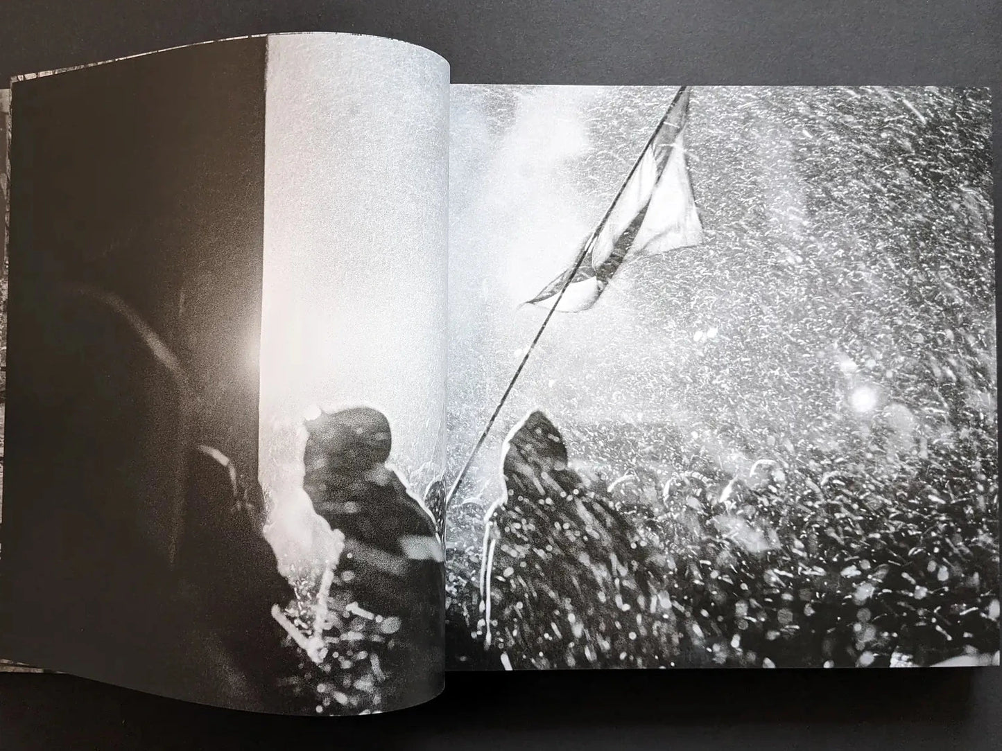 Inside spread from Oleksandr Glyadyelov showing a dense night-time protest scene in falling snow.