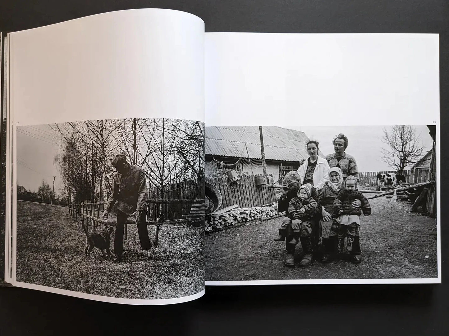 Inside spread from Oleksandr Glyadyelov with an elderly man and dog in a village lane and a multigenerational family posing in a farmyard.