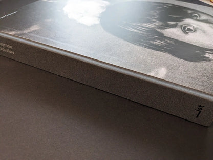 Cloth-bound spine of the “Oleksandr Glyadyelov” photobook by IST Publishing, with the title printed along the edge.