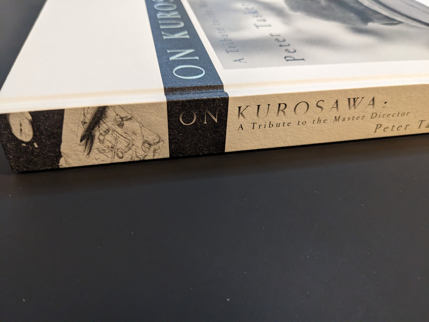 Close-up of the spine reading ‘ON KUROSAWA: A Tribute to the Master Director — Peter Tasker’; hardcover detail (Zen Foto Gallery, 2018).