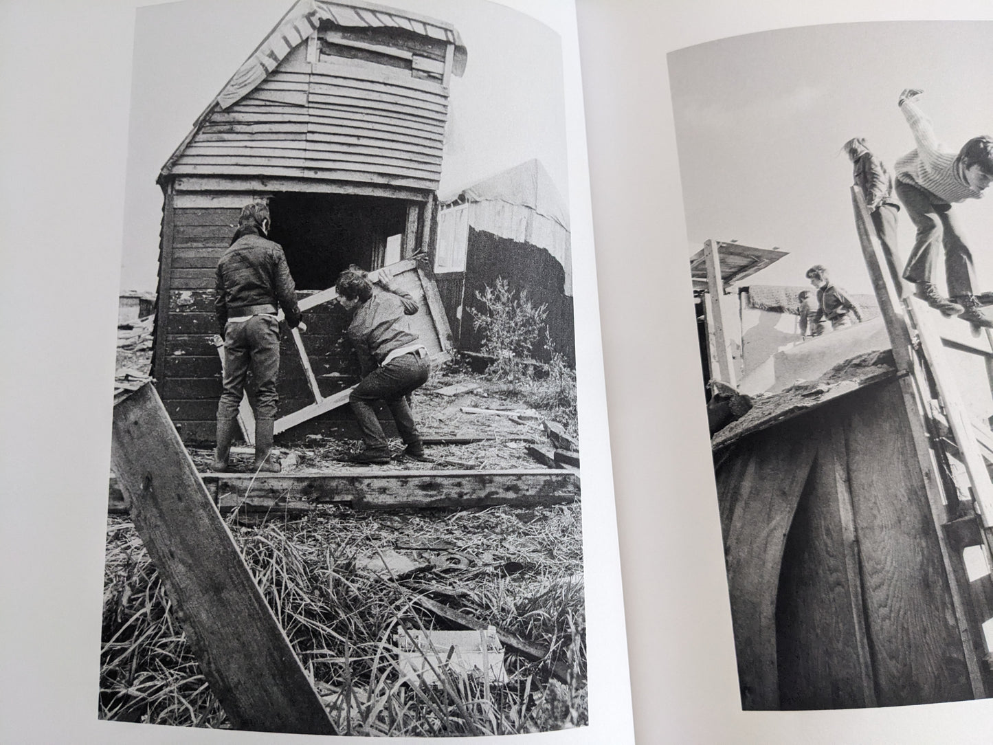 Open spread with black-and-white images of children carrying boards and working on a hut.