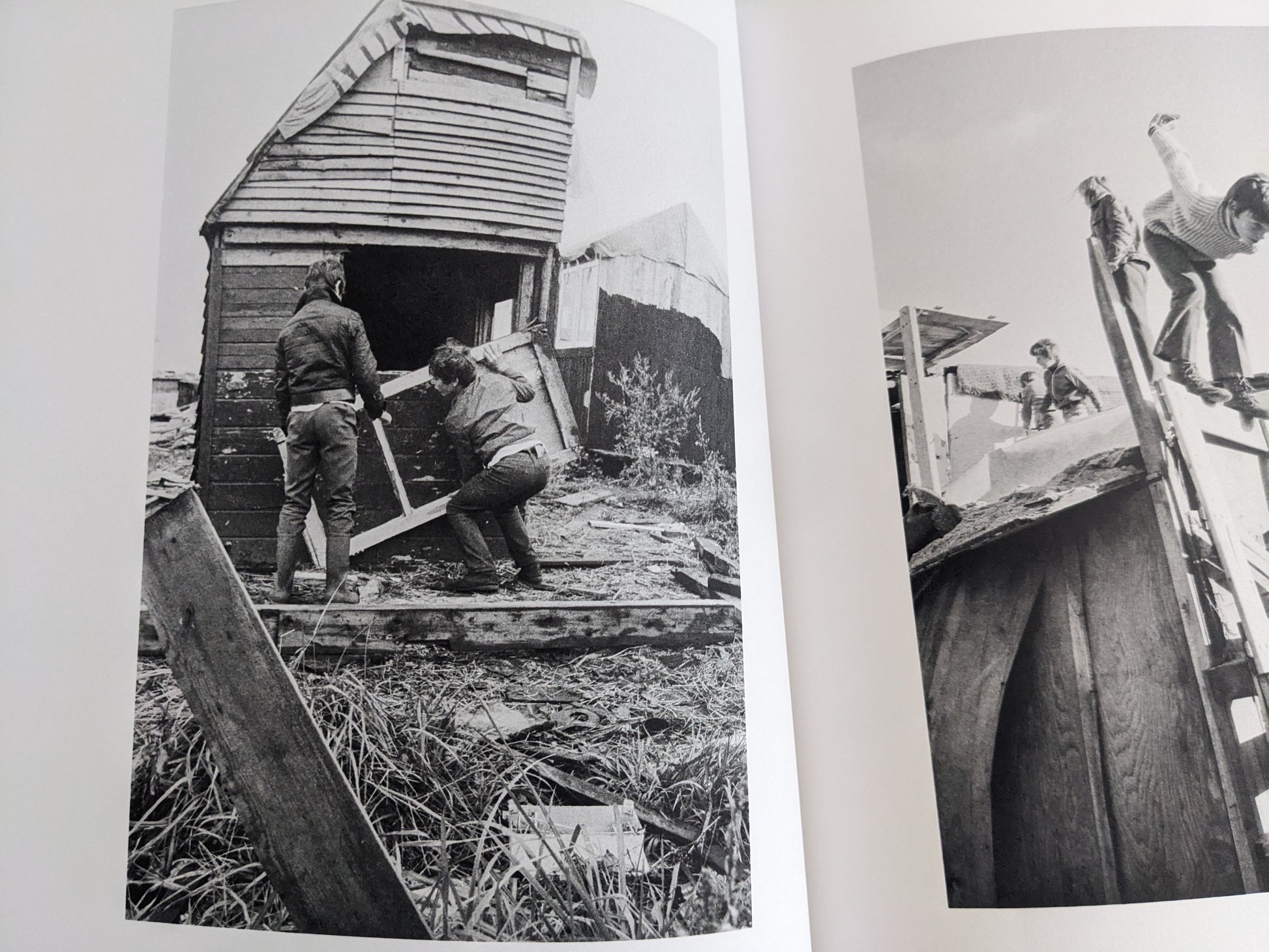 Open spread with black-and-white images of children carrying boards and working on a hut.