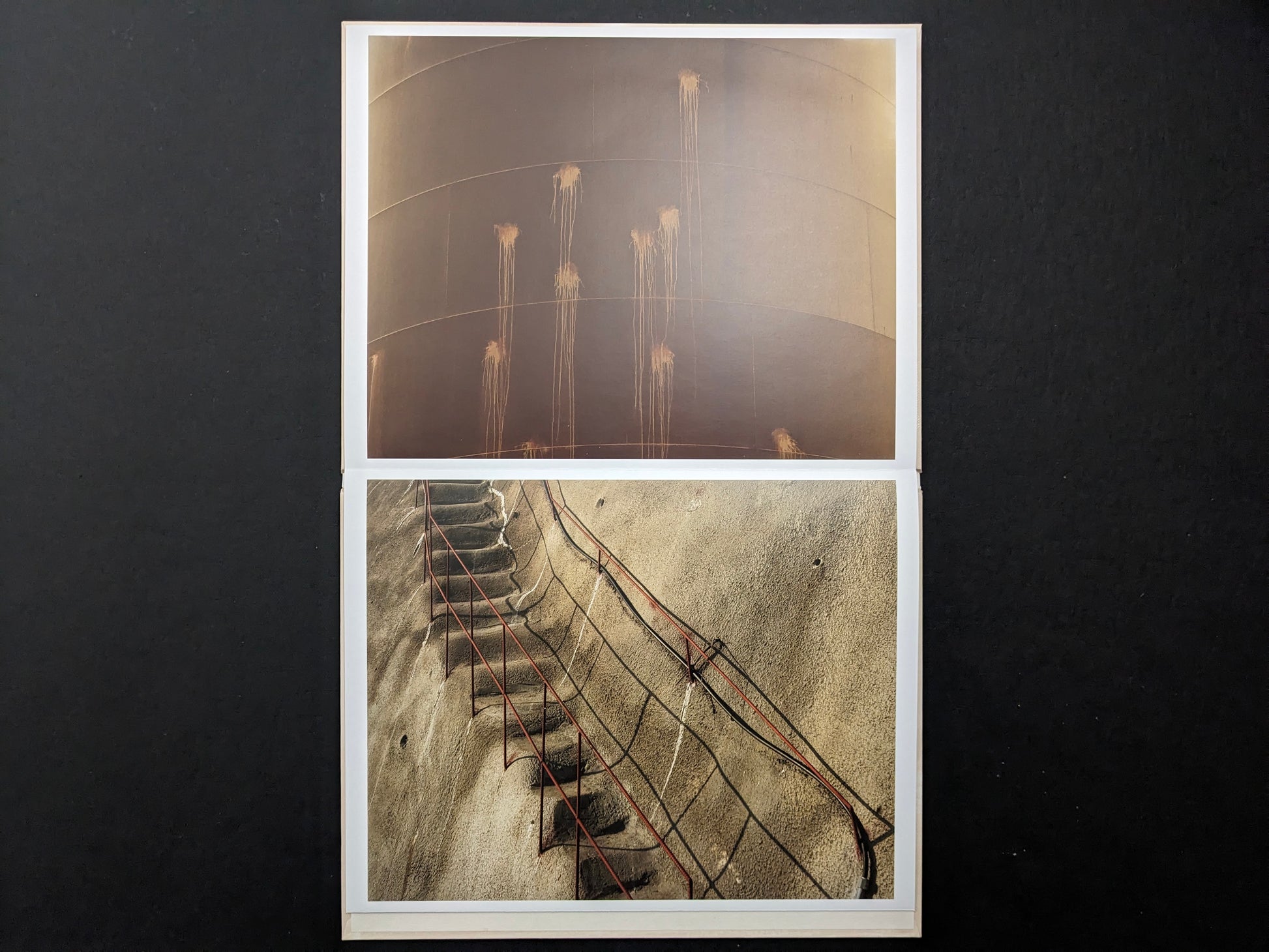 Leporello spread from Painting by Toshio Shibata showing an industrial tank wall with streaks and a concrete slope with red railings.